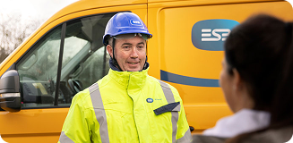 Technician standing in front of ESB Networks van.